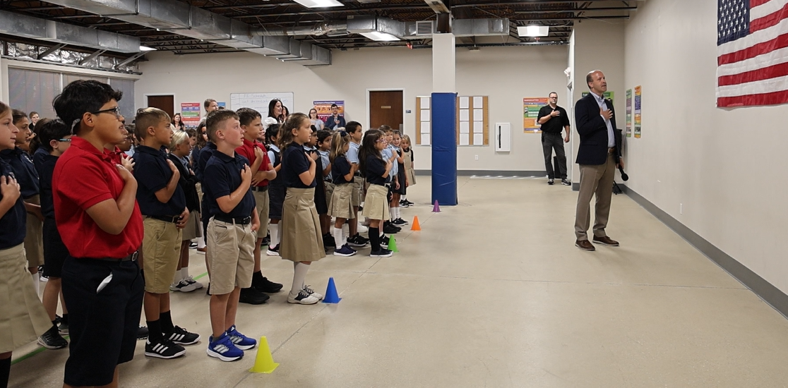 Students at an American classical school reciting the Pledge of Allegiance at morning assembly.