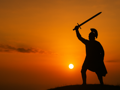 A warrior holding a sword high against a sunset, symbolizing strength and joy in a noble cause
