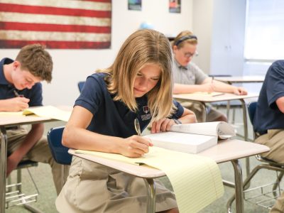 Students in a classroom demonstrating diligence in study at Columbus Classical Academy.