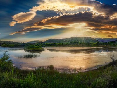 Golden sunrise over a quiet landscape, symbolizing a fresh start and new mercies each morning at the beginning of the school year.